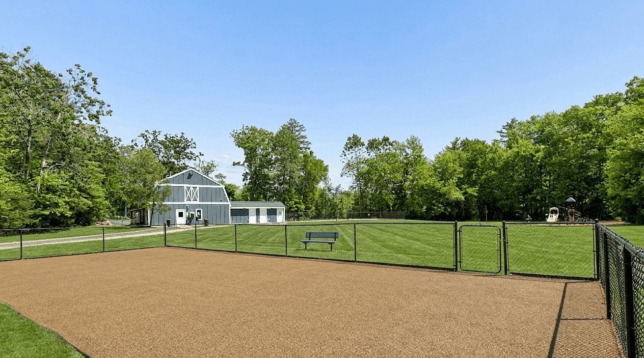 A baseball field with a fence and a bench.